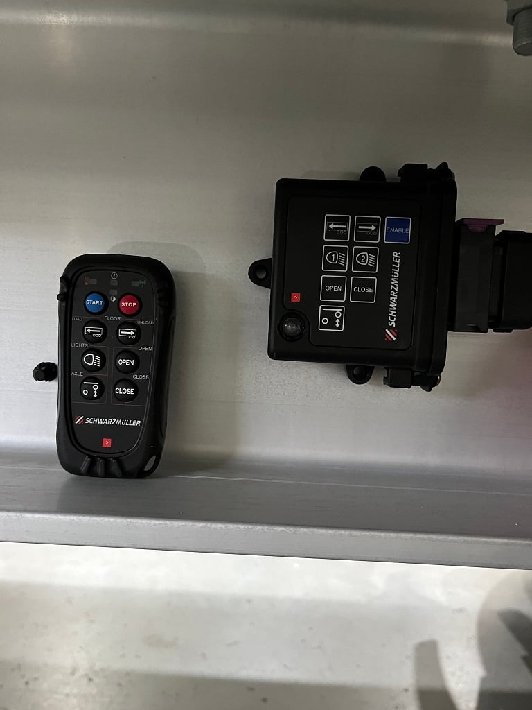 Radio remote control with control of work lights or lift axle