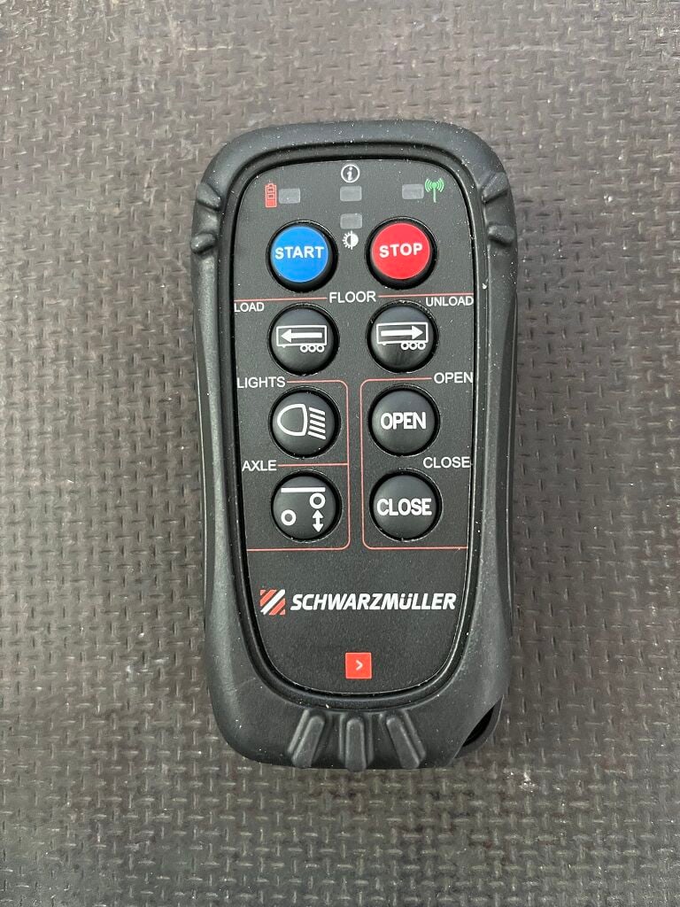 Radio remote control with control of work lights or lift axle